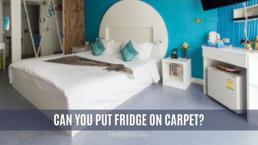 Mini fridge on carpet floor inside bedroom
